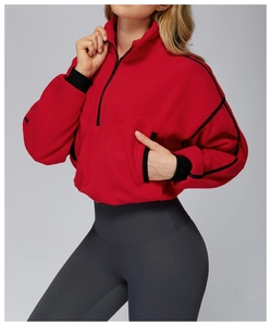 Detail of red polar fleece running jacket featuring high stand collar and ribbed cuffs