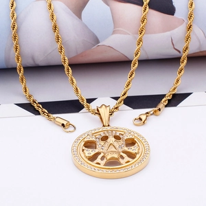 Detailed shot of golden hip hop skull pendant with rhinestones on a twist chain