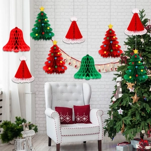 Festive Christmas honeycomb paper ornaments including red and green trees and bells hanging