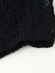 Close-up of elegant black lace fabric with 3D texture and intricate floral bubble pattern