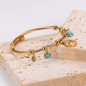 Golden stainless steel twisted rope bracelet with turquoise beads and heart pendant