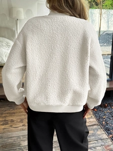 Rear view of white plush long-sleeved sweatshirt with ribbed cuffs and hem detail