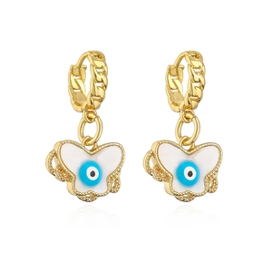 Macro detail of gold plated butterfly earrings with blue evil eye and white enamel