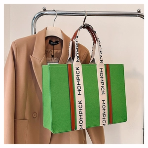 Detailed view of large green felt tote bag featuring MOMPICK branded woven straps