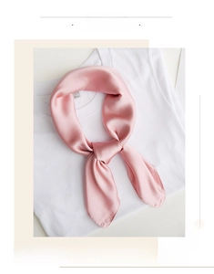 Close-up of soft pink silk scarf with lustrous texture and elegant knotting detail