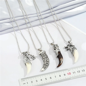 Detailed view of punk wolf tooth pendants showing retro patterns and size measurements
