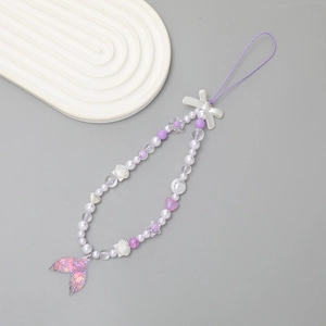 Detail of purple beaded phone wrist strap with mermaid tail and bowknot pendants