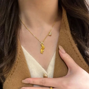 24k gold-plated koi fish and ancient coin necklace with zircon heart pendant on model