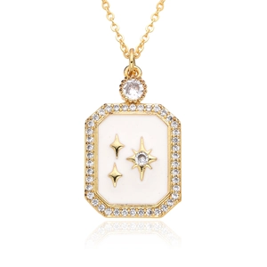 Macro detail of gold plated crescent moon pendant with white enamel and sparkling zircons