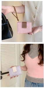 Detail of rose embossed vintage wallets in pink and lilac with stylish lanyards