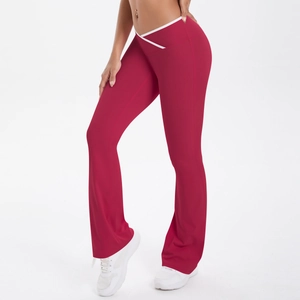 Detail of red flare yoga pants with high waisted white cross-over V-shape waistband