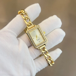 Close-up of gold square quartz watch with a chain bracelet and sparkling crystal bezel