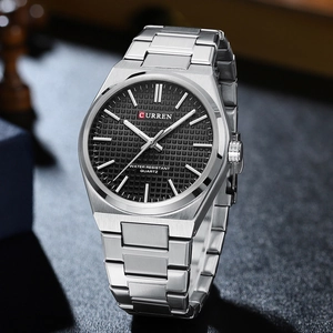 Detailed macro view showing the brushed metal strap and grid textured dial of this watch