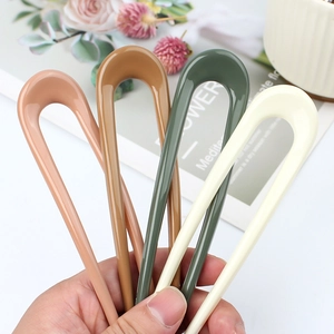 Set of four minimalist U-shaped hair pins in matte pastel colors for summer bun styles