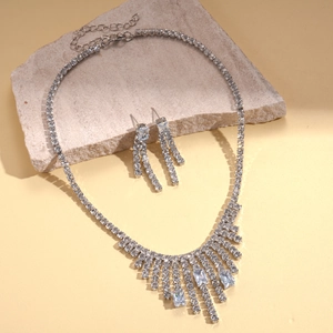 Silver geometric tassel necklace set with sparkling cubic zirconia on stone display