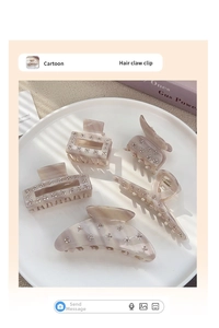 Detail of marble acetate hair claw clips set with rhinestone flower accents in a dish