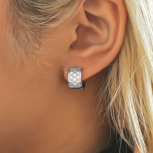 Square silver hoop earrings with micro-pave zircons worn by a female model
