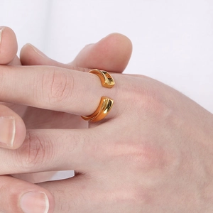 Minimalist gold plated stainless steel open ring with V-groove design worn on finger