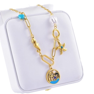 Golden ocean theme layered necklace with seahorse, starfish, and turquoise heart pendant