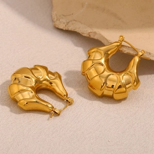 Polished 18K gold plated hollow croissant earrings on an elegant stone surface