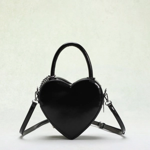 Creative heart-shaped handbag with glossy black finish and metallic chain strap