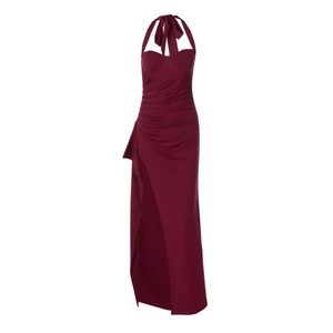 Detail of burgundy halter neck dress featuring side high slit and ruched waist design