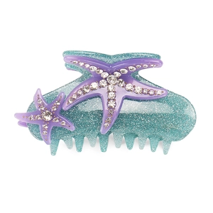 Detail of the turquoise glitter claw clip with purple rhinestoned starfish decorations