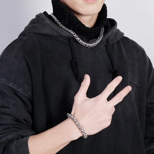 Close-up of hip-hop style silver stainless steel chain necklace and bracelet on male model