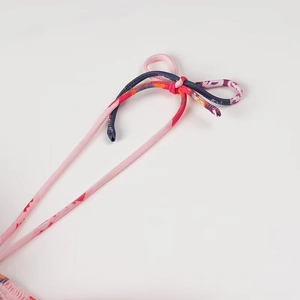 Detail of pink and blue ethnic print shoulder straps tied in a knot on beach dress