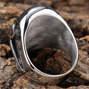 Gothic silver skull ring in stainless steel with brushed finish on bark background