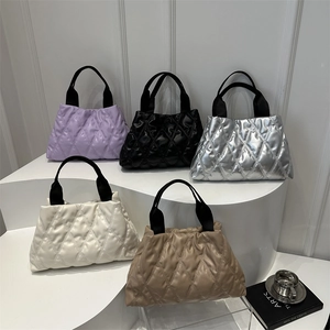 Quilted tote bags in multiple colors featuring puffer diamond patterns and black straps