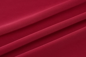 Detail shot of deep wine red chiffon fabric texture with soft natural pleats and folds