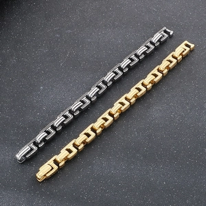 Detail of vintage silver and gold mixed metal Cuban link bracelets with embossed patterns