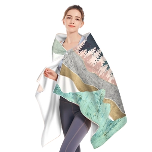 Detail of hooded microfiber beach towel featuring soft texture and abstract landscape print