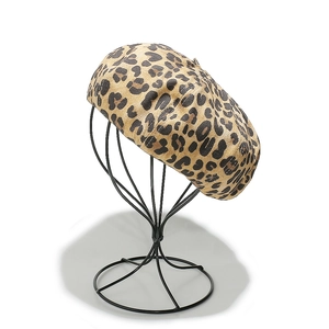 Classic leopard print beret hat for women on a metal stand for autumn winter fashion