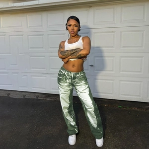 Detail of high waist straight-leg trousers with green and white irregular print