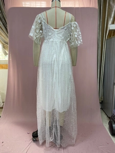 Detail of V-back bridal dress featuring delicate lace embroidery and dot tulle texture