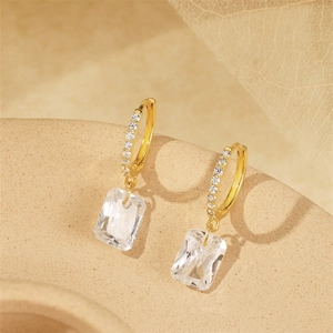 Detailed close-up of gold S925 silver hoop earrings with a rectangular crystal pendant