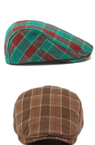 Close-up of red-green and brown plaid patterns on British style flat caps