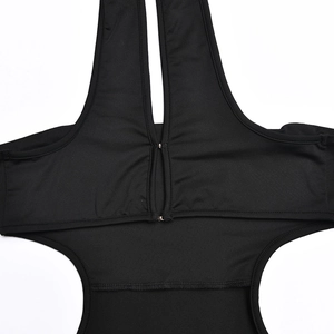 Close-up of black halter neck bodysuit with front button closure details on elastic fabric