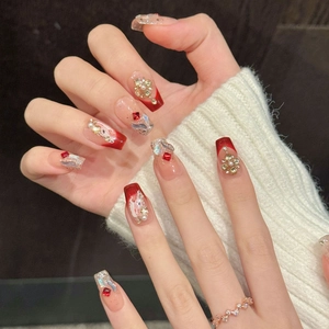 Handmade red and nude gradient press-on nails with golden floral and pearl accents