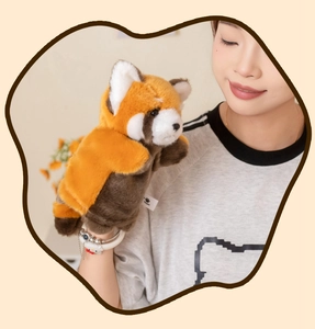 Detail of soft plush red panda hand puppet with realistic fur on model's hand