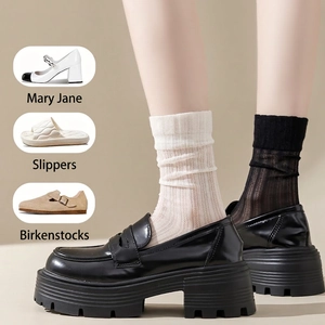 Sheer ribbed mid-calf socks in black and off-white paired with platform loafers
