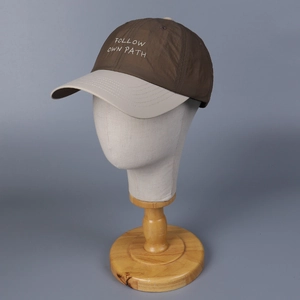 Detail of contrast baseball cap with FOLLOW OWN PATH embroidery and breathable eyelets