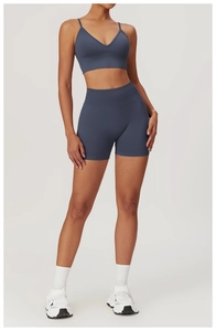 Detail of stone blue high waist seamless yoga shorts and sports bra set on model