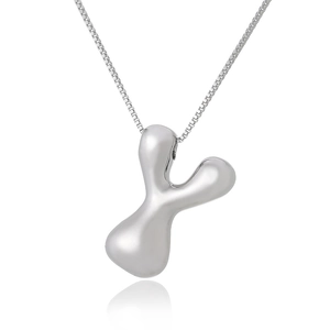 Detailed view of silver Y-letter pendant with polished box chain on reflective surface