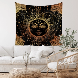Detail showing the sun and moon pattern on black bohemian tapestry in a cozy living room