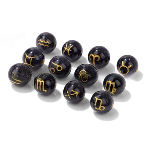 Macro shot of 10mm blue goldstone beads featuring gold zodiac signs for DIY jewelry