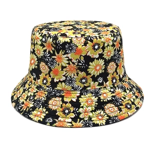 Detailed macro view of black floral bucket hat with yellow daisy pattern and cotton texture