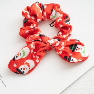 Detail of red Christmas scrunchie with snowman print and cute rabbit ear knot detail